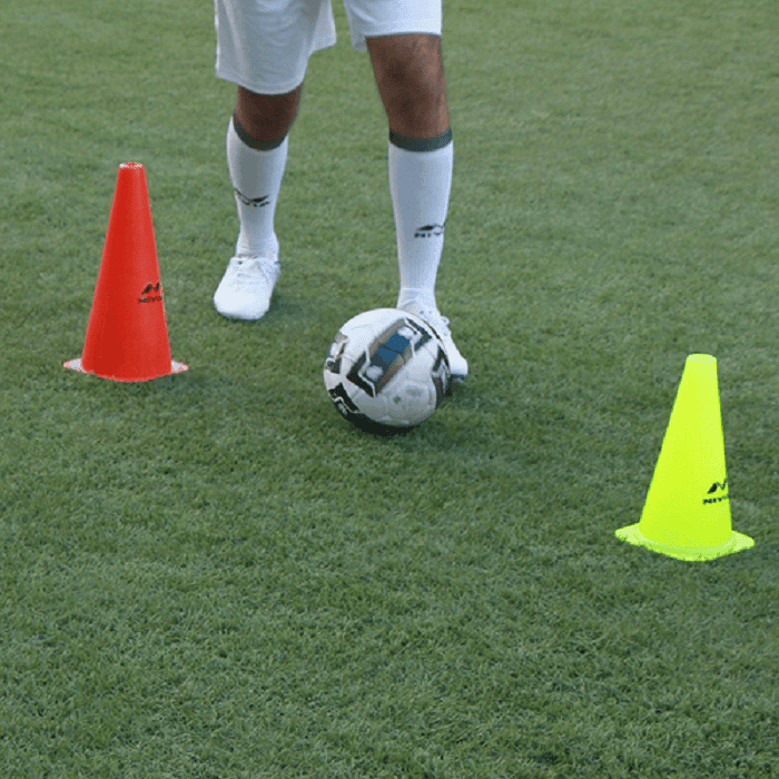 Football Player Jogging and Jump between Cone Markers on Green a